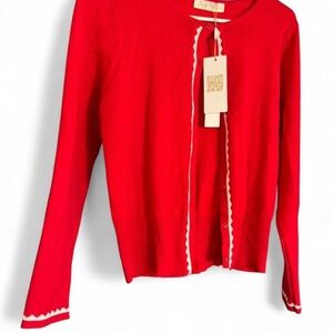 Red cardigan sweater with white scallop trim